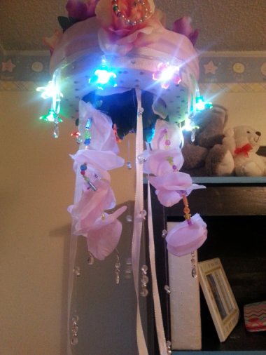 And on the other side of the, er, taste spectrum, here's a light-up baby mobile comprised, as far as I can tell, of stuff found at the bottom of some boxes in this lady's basement. By xoMoreSugarPleasexo