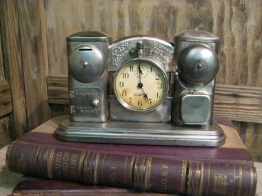 This is a bit like the Hootenanny. "Vintage Industrial Antique 1908 Darche Clock Flashlight Alarm Clock Safe Piggy Bank" sold by VintageIronWorks