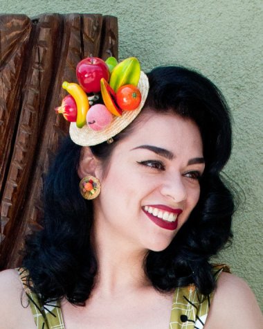 As goofy as the vintage fruit hat was, this modernized version is really not much of an improvement. I do love how they styled her, though.