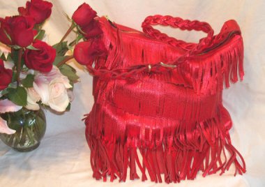 Metallic lipstick red fringed leather purse. That's a whole lot of look. By DBag. Wait, that's not right. By DLeather