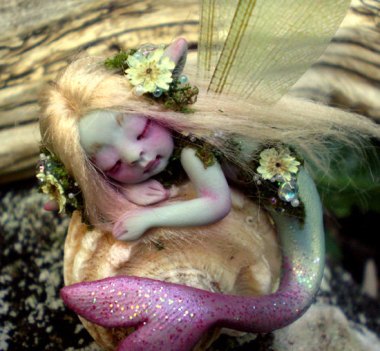For the mermaid enthusiast with everything: the tiny figurine of a mermaid with pink eye. By ScarletsBones