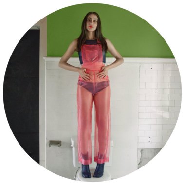 As idiotic as these sheer pink overalls are, I included them because shes standing on a toilet. By ShopRachelRector who should consider taking her pictures in the kitchen.