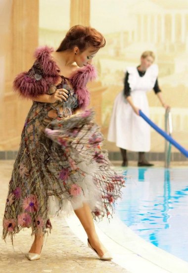 As questionable as the dress is, I really included this because of the "maid" in the background, cleaning WITH A POOL NOODLE. By Jarmolowska