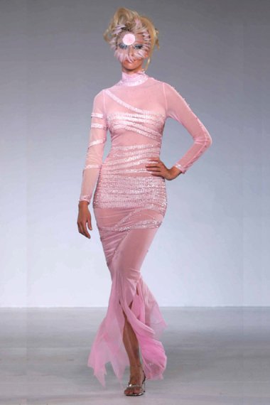 I can understand why she'd want to cover her face while wearing this ghastly thing, but she's not even doing that right. By RoutaHighEndFashion