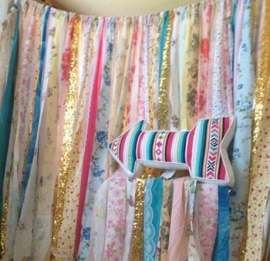 This may looks like a mismatched collection of fabric scraps tied together, but no. It's a boho headboard. Leave it to Etsy. By ChangesByNeci