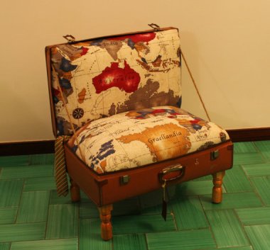 "Poltrigia comes out of an old cardboard suitcase that has captured the world inside." It should read "Adorable chair overshadowed by bizarre description." CreazioniDesign