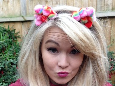 Rainbow pom pom panda ears. I don't understand what they mean, but she does look awfully cute. By Love2SparkleUK