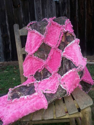 Pink and camo crib-sized quilt. (Shudder.) By Sewnbyangie