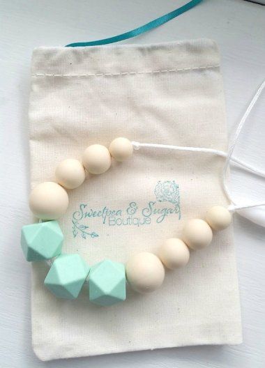 You know how babies love to pull and chew on your jewelry? Well, this is a silicone teething necklace that's both freezer and dishwasher safe. What a great idea! By Sweetpeasugarshop
