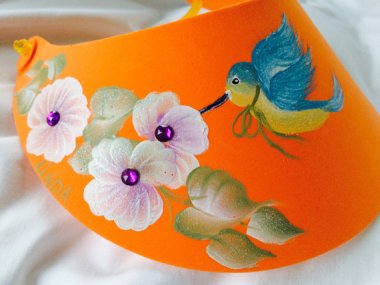 Where else can you see a sun visor with a derpy painting of a hummingbird wearing a ribbon? Just sayin.