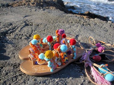 And speaking of pom poms, these "gladiator sandals" are lousy with them.