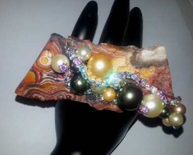 You know how in some cultures, growing your pinkie nail extra long indicates that you don't do manual labor? Well, this full hand plus ring tells the world you don't have a job at all. Or any taste or sense, either.