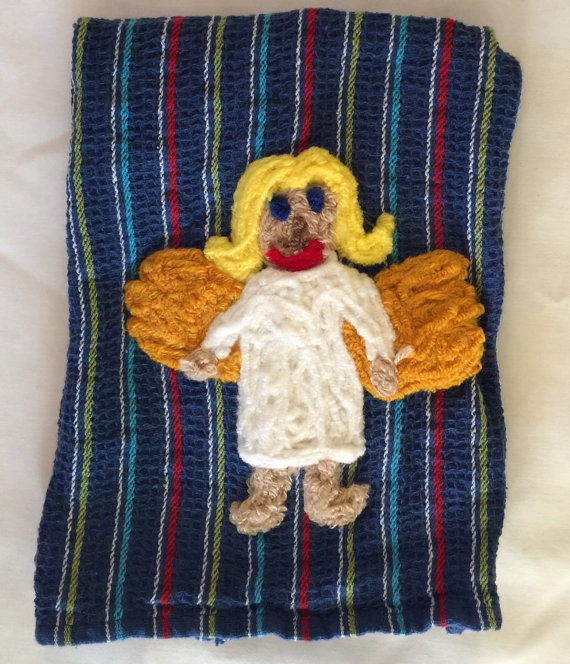 This is a kitchen angel dish towel. She's meant to keep your kitchen safe, presumably from people with taste.