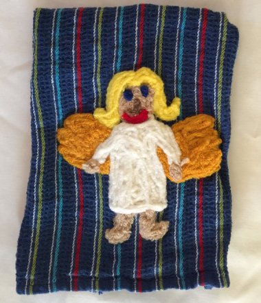 This is a kitchen angel dish towel. She's meant to keep your kitchen safe, presumably from people with taste.