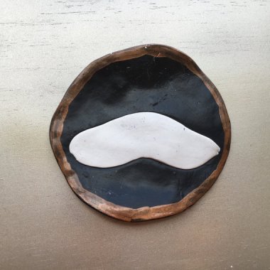 Mustache coaster that fails both as a mustache and a coaster.